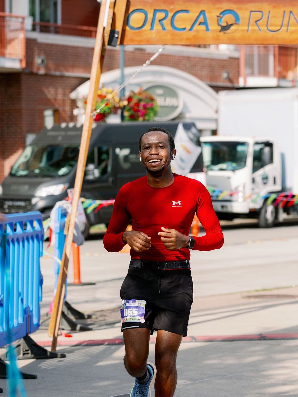 Richard running through the finish of the Orca Run